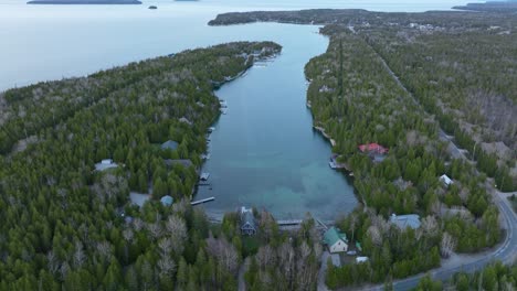 Ship-wreck-at-Bruce-peninsula,-Ontario,-Canada-in-early-spring-and-lake-Huron,-Drone-approaches-the-Ship-and-tilt-down