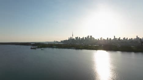 Tommy-Thompson-park-and-bay-in-Toronto,-Ontario,-Canada,-Distant-view-on-the-city-and-flying-forward,-close-to-the-ground