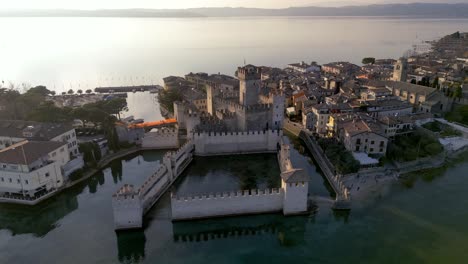 Aerial-view-Sirmione-italy,-peninsula-resort-town-on-lake-garda,-mediterranean-surroundings-historical-town-with-castle