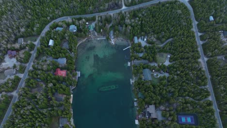 Ship-wreck-at-Bruce-peninsula,-Ontario,-Canada-in-early-spring-and-lake-Huron,-Drone-approaches-the-Ship