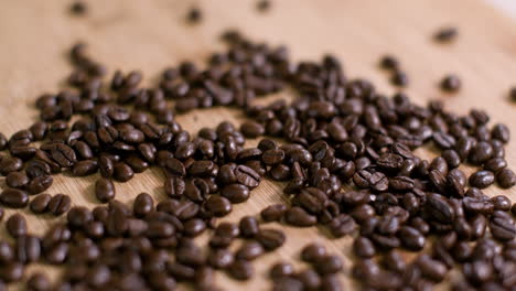 Pile-of-Coffee-Beans-on-Wooden-Surface-Slow-Fly-Over-01
