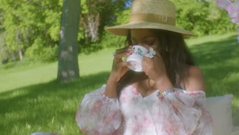 Black-Woman-drinking-tea-coffee-in-park-picnic-close-up