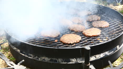 Large-grill-with-many-burgers-being-cooked-on-an-outside