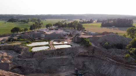 Aerial-dolly-shot-from-a-drone-of-quarry-and-heavy-machinery-in-pomeranian-district-in-Poland