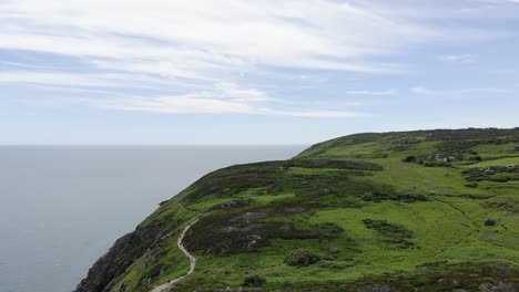 Beautiful-green-landcape-mountain-with-walk-path-and-blue-ocean-on-its-side