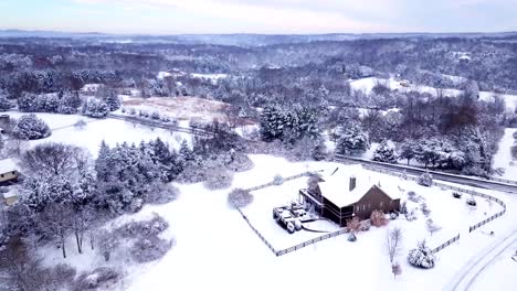 A-drone,-aerial,-birds-eye-view-fly-over-of-a-country-neighborhood-in-the-mountains-of-Virginia-after-a-winter-snow