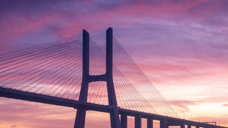 Timelapse-of-a-colorful-and-beautiful-sunrise-in-Vasco-da-Gama-Bridge-in-Lisbon,-Portugal