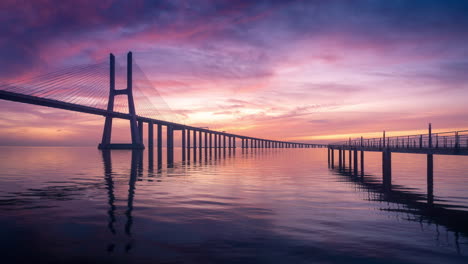 Timelapse-of-a-colorful-and-beautiful-sunrise-in-Vasco-da-Gama-Bridge-in-Lisbon,-Portugal