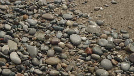 pebbles-in-sand-with-wave-15-seconds