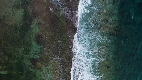 Bird's-eye-view-of-Indian-Ocean-waves-crushing-on-rocks-in-middle-of-ocean-amazing-drone-rare-footage-filmed-in-6k-downsized-to-4k
