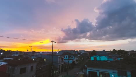 Skies-turning-bright-orange-in-the-horizon-during-sunset-in-the-peaceful-city-of-Dasmariñas,-Cavite,-Philippines---Time-lapse