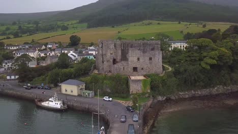Point-of-interest-drone-shot-of-King-John-castle-in-Carlingford-town-with-mountains-in-the-background