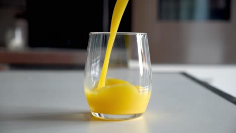 Slow-Motion-Glass-filled-with-orange-juice---4k-60fps