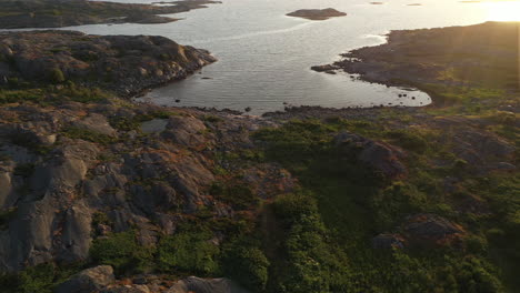 An-aerial-shot-of-a-rocky-bay-during-a-sunset