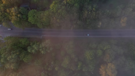 Drone-aerial-view-of-road-during-foggy-morning