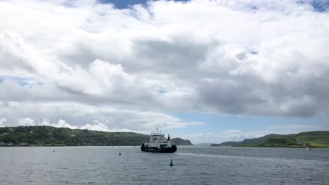 A-large-passenger-boat-sailing-out-towards-the-Sound-of-Mull-on-a-calm-Summer-day-|-Oban,-Scotland-|-HD,-24-fps