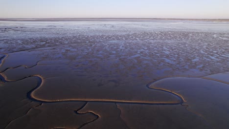 Endless-wetlands-and-river-with-deep-branches-cascades-through,-aerial-drone-fly-forward-shot