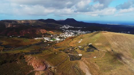Spectacular-white-luxury-town-in-volcanic-landscape-of-Lanzarote,-aerial-drone-view