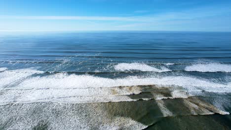 4K-aerial-drone-shot-floating-above-ocean-tide-at-Seaside,-Oregon-beach