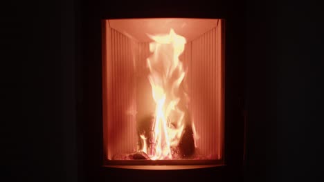 Home-is-warmed-by-burning-fireplace-with-firewood,-orange-flame,-static-view