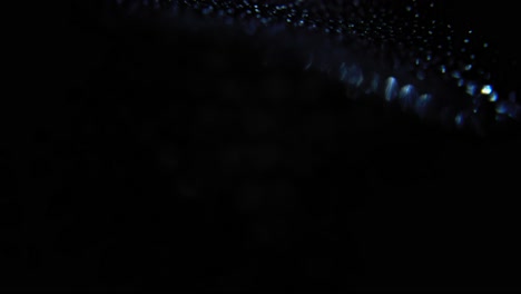 A-glittering-black-object-is-shown-upside-down-in-a-video