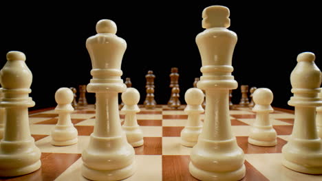 Chess-Board-Pieces,-Macro-Pull-Back-Across-Board-Between-White-King-and-Queen,-Slow-Motion