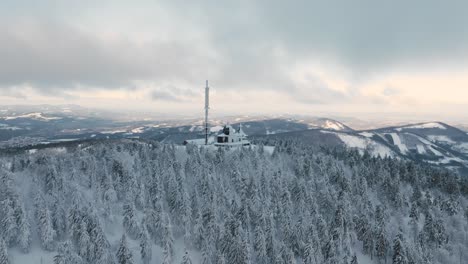 winter-drone-orbit-around-the-Radhost-chappel-during-golden-hour,-speeded,-Beskydy-4k