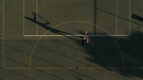 Aerial-footage-of-a-female-tennis-player-playing-tennis-on-a-tennis-court