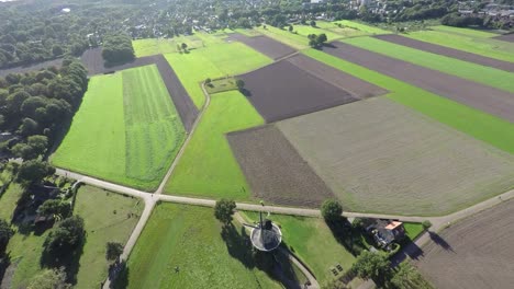 Aerial-footage-of-Windmill-in-green-fields