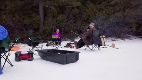 Get-an-aerial-view-of-Ice-Fishing-on-Fitzgerald-Pond,-Maine