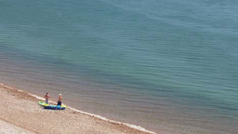 Two-men-and-a-boat-on-a-shore-near-the-town-of-Budleigh-Salterton