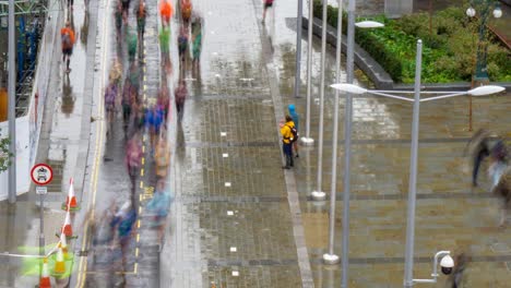 Tilt-time-lapse-of-marathon-runners-running-through-city-centre