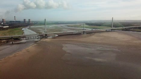 Aerial-shot-heading-towards-Widnes-transport-bridge-with-power-station-smoking-in-the-background