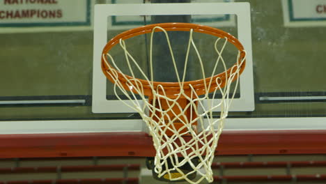 Closeup-of-basketball-hoop-and-net-as-balls-are-shot-at-it