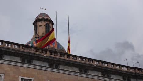 Spanish-flag-blowing-in-wind,-day-time-Barcelona