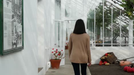 Young-Woman-Walking-Through-Greenhouse