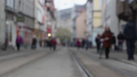 Blurry-people-moving-in-downtown-Erfurt,-historic-city-in-Germany