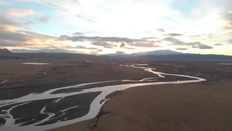 Wide-Panning-Shot-of-Sunrise-Over-Icelandic-River