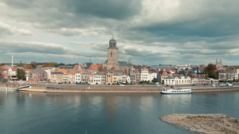 Aerial-view-of-Dutch-medieval-city-Deventer-slowly-panning-up-revealing-the-whole-city-under-a-dramatic-overcast-cloudy-sky