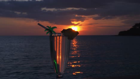 Sliding-shot-of-a-cocktail-at-a-beautiful-sunset
