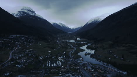 Aerial-shot-of-Stryn-surrounded-by-mountains-at-Twilight,-Norway