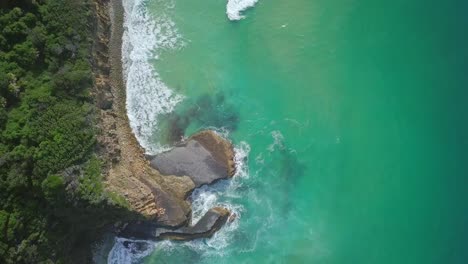 Stunning-aerial-morning-flight-over-turquoise-water-and-sharp-cliffs,-Australia