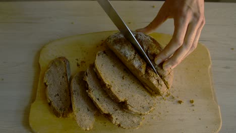Top-view-shot-of-female-cutting-bread