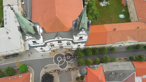 People-wedding-in-front-of-Church-of-Saint-Andrew---Kostel-svateho-Ondreje,-Komarov,-Slovakia---Aerial-Drone