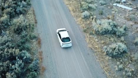 Drone-shot-of-car-driving-on-empty-mountain-road