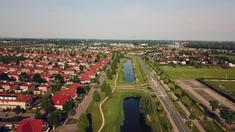 Drone-view-of-an-area-of-Dronten-along-a-canal,-Flevoland,-The-Netherlands