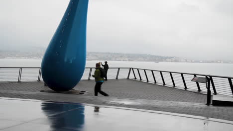 Pedestrians-walking-near-a-city's-harbour