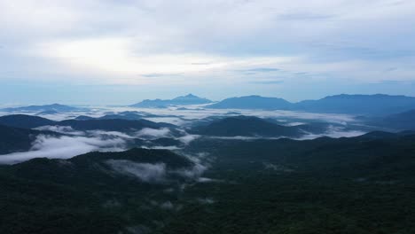 Drone-shot-of-a-beautiful-scenery-of-the-high-mountains-on-the-cloud-at-sunrise