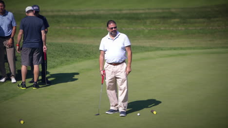 Golfer-putting-on-the-green-on-a-beautiful-sunny-day