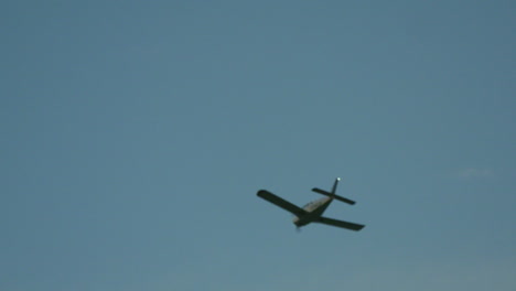 A-small-plane-flies-through-a-clear-blue-sky